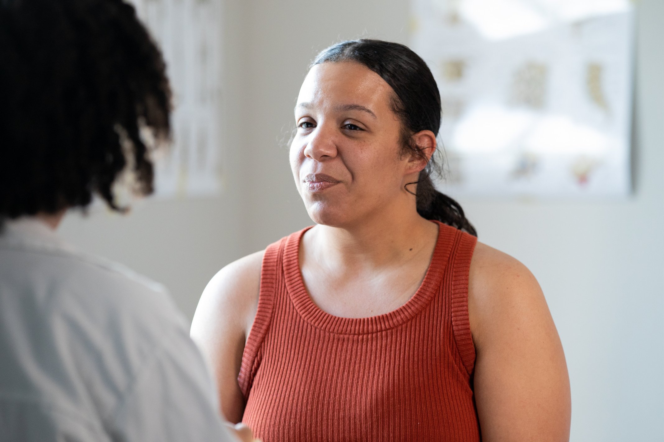 Mid adult patient communicating with her primary care doctor